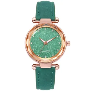 Detail view of emerald green glitter dial with diamond markers and rose gold case