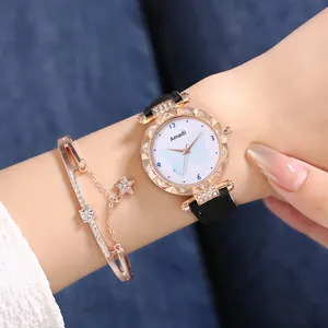 Gros plan d'une montre en or rose avec cadran papillon et bracelet étoile assorti