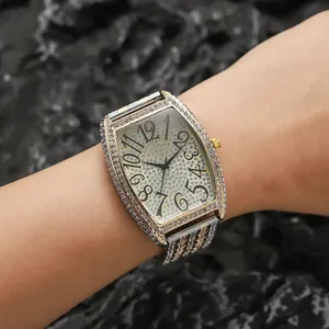 Luxurious gold tonneau watch for men with full diamond setting and bold black numerals