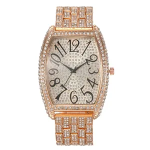 Luxurious rose gold tonneau watch with full diamond setting and artistic Arabic numerals