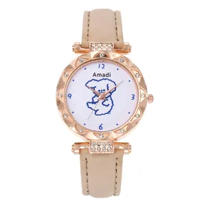 Detail of rose gold quartz watch with rhinestone bezel and cartoon dog dial on beige leather