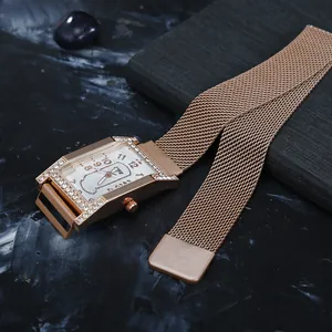 Detail of rose gold rectangular watch featuring rhinestone bezel and Milanese mesh strap