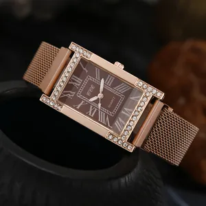 Detail of rose gold quartz watch with H-shaped rhinestone case and brown Roman dial
