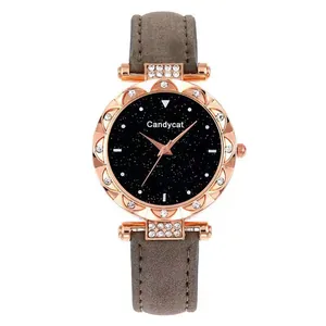Detail of rose gold starry sky watch face with crystal bezel and brown leather strap