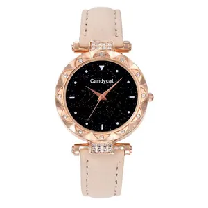 Detailed close-up of rose gold rhinestone bezel and starry black dial on a beige strap watch