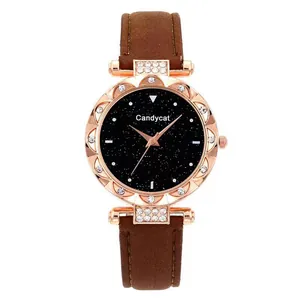 Detailed view of women's starry sky watch with rose gold rhinestone case and brown leather strap