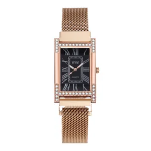 Close-up of rose gold rectangular watch with crystal H-shaped case and black dial