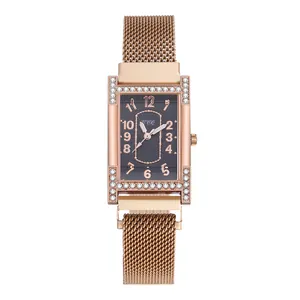 Macro detail of rectangular rose gold mesh band watch with rhinestone-encrusted case edges