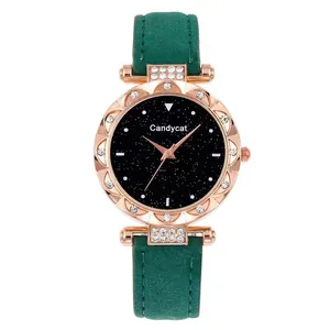 Detail of rose gold watch with sparkling starry sky dial and green frosted leather strap