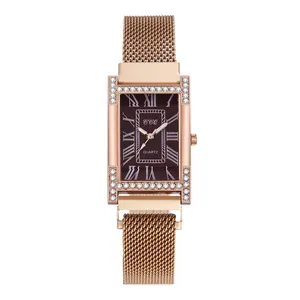 Detail of rose gold rectangular quartz watch with crystal bezel and mesh band