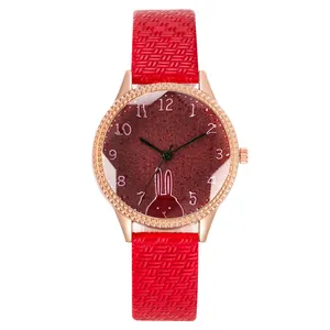 Detail of red glitter dial with white rabbit motif and rose gold diamond-cut bezel