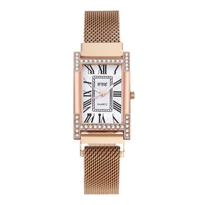 Detail of rose gold rectangular quartz watch with Roman numerals and crystal bezel