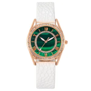 Women's rose gold watch with emerald green textured dial and white leather strap
