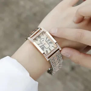 Women's rectangular quartz watch with silver and rose gold steel strap on wrist