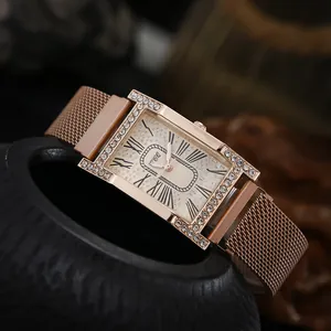 Detail of rose gold rectangular watch with rhinestone bezel and starry sky dial
