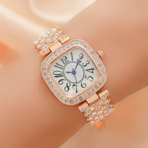 Elegant rose gold square watch with crystal bezel and blue hands worn on the wrist