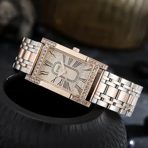 Detailed macro shot of rectangular rose gold watch with diamond bezel and roman numerals