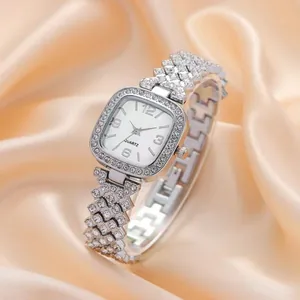 Elegant square silver quartz watch for women with rhinestones on silk background