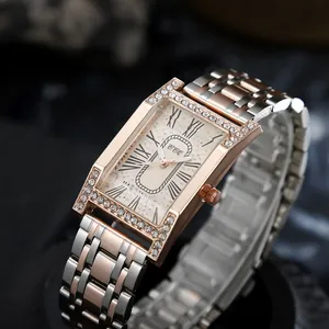 Macro shot of square rose gold watch case with crystal bezel and Roman numeral dial