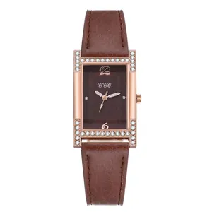 Detail of square rose gold watch case with crystal inlay and brown leather strap