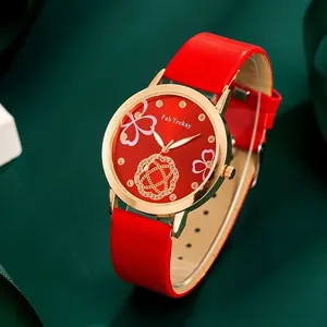Macro detail of red floral dial with crystal markers and rose gold case on women's watch