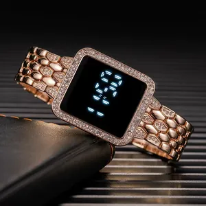 Macro view of rose gold digital watch with crystal-encrusted bezel and metallic strap