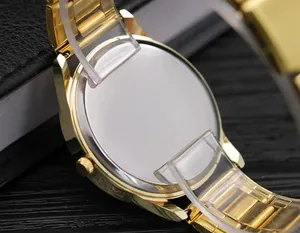 Detailed macro view of the polished gold-tone stainless steel watch case back and strap