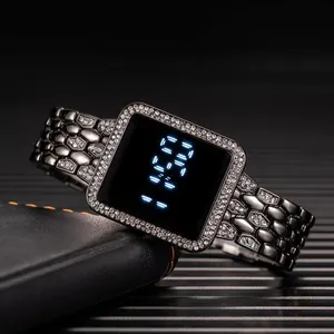 Macro detail of square LED digital watch with rhinestone bezel on leather wallet