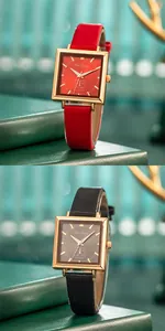 Detail of square gold watches with red and black leather straps in a vintage gift setting