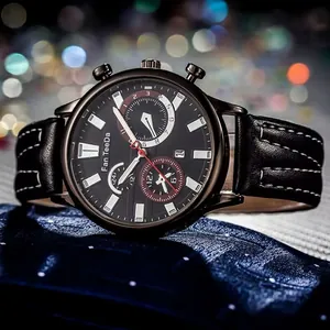 Detail of chronograph men's business watch with black leather strap and calendar dial