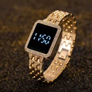 Macro detail of gold LED watch with square diamond bezel and sparkling rhinestone band