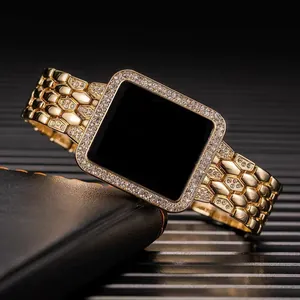 Detail of luxury gold-plated square watch case and chain strap inlaid with crystals