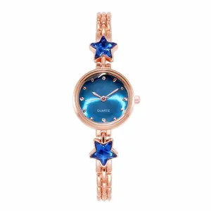 Detail of rose gold watch band featuring blue star crystals and a sunray blue dial