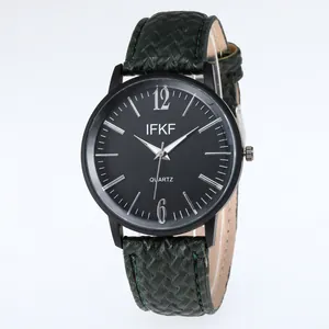 Classic business quartz watch with black dial and dark green woven strap on white background