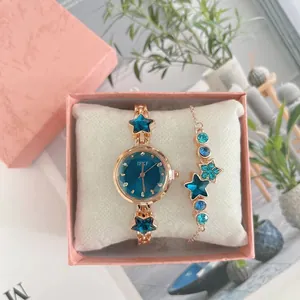 Detail of rose gold watch and star bracelet set in a pink gift box with soft pillow