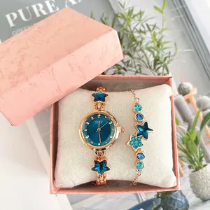 Rose gold watch and star bracelet set with blue gemstones in a pink gift box
