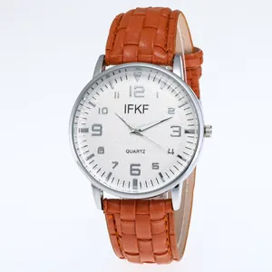 Detail of classic white dial with Arabic numerals and silver case on a brown leather strap