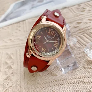 Détail du bracelet en cuir rouge avec clous et cadran avec chiffres romains