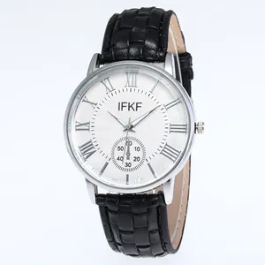 Close-up of white quartz watch dial with Roman numerals and black leather strap