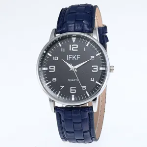 Business quartz watch with black dial and blue embossed leather strap on white background