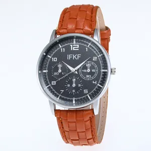 Close-up of brown textured leather strap and silver case of a men's business quartz watch