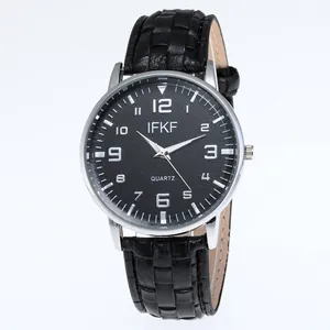 Detailed macro view of the black textured leather strap and silver quartz watch case