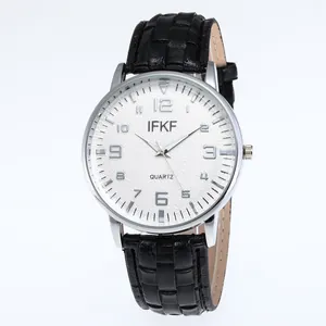 Macro view of white quartz watch dial with black numerals and textured black leather strap