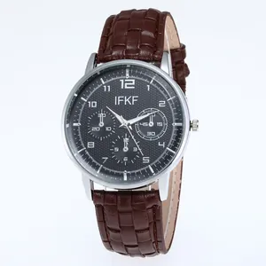 Detail of quartz watch with black honeycomb dial and textured brown leather strap