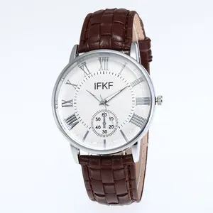Detail of white textured dial with silver Roman numerals and brown leather strap watch