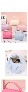 Detail of quilted leather makeup bags in five colors with soft handles and zipper
