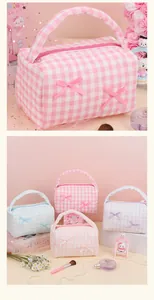 Close-up of soft plaid fabric texture and bow details on a portable cosmetic bag