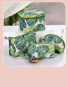 Detail view of canvas travel toiletry bag set with green tropical monstera leaf prints