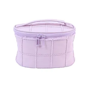 Light purple quilted cosmetic bag with plush trim and double zipper handle