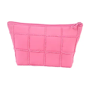 Quilted pink makeup bag with fringe detail and secure zipper for travel storage